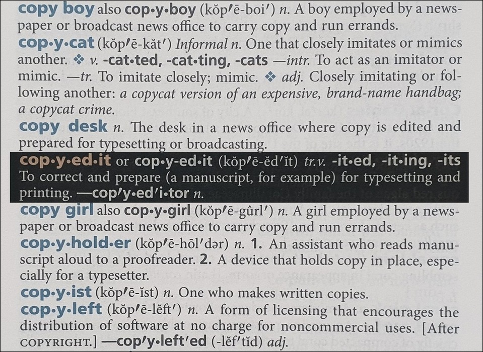Photo of a few entries in the American Heritage Dictionary, fifth edition. The entry for 'copyedit or 'copy-edit' is highlighted, defining the word as: 'To correct and prepare (a manuscript, for example) for typesetting and printing.'